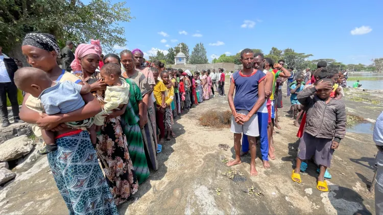 People gathered by the water with The Timothy Initiative